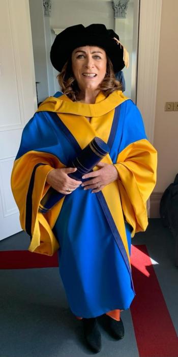 Mary wearing official university college of Dublin dress robes